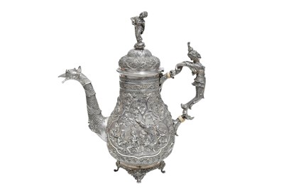 Lot 183 - λ AN UNMARKED BRITISH COLONIAL BURMESE REPOUSSÉ SILVER COFFEE POT