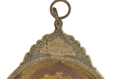 Lot 187 - A QAJAR BRASS ASTROLABE WITH FOUR PLATES