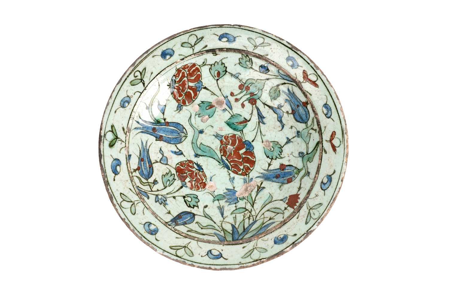 Lot 137 - AN IZNIK POTTERY DISH WITH RED-SPECKLED BLUE TULIPS