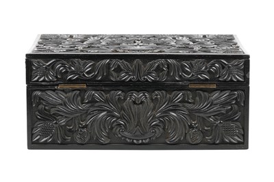 Lot 165 - λ A SINHALESE CARVED EBONY LIDDED BOX WITH IVORY-INLAID FLOWER VASE DECORATION