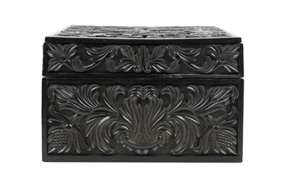Lot 165 - λ A SINHALESE CARVED EBONY LIDDED BOX WITH IVORY-INLAID FLOWER VASE DECORATION