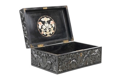 Lot 165 - λ A SINHALESE CARVED EBONY LIDDED BOX WITH IVORY-INLAID FLOWER VASE DECORATION