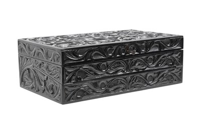 Lot 168 - λ A SINHALESE CARVED EBONY PORTABLE WRITING CABINET WITH IVORY-INLAID LIONS