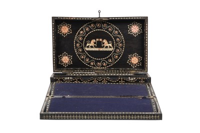 Lot 168 - λ A SINHALESE CARVED EBONY PORTABLE WRITING CABINET WITH IVORY-INLAID LIONS