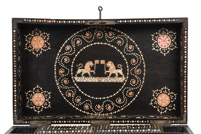 Lot 168 - λ A SINHALESE CARVED EBONY PORTABLE WRITING CABINET WITH IVORY-INLAID LIONS
