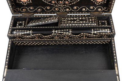 Lot 168 - λ A SINHALESE CARVED EBONY PORTABLE WRITING CABINET WITH IVORY-INLAID LIONS