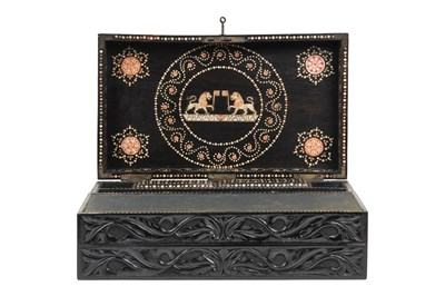 Lot 168 - λ A SINHALESE CARVED EBONY PORTABLE WRITING CABINET WITH IVORY-INLAID LIONS