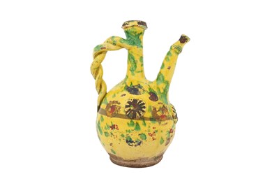 Lot 121 - A GOLD-ENAMELLED AND GREEN-SPLASHED YELLOW-GLAZED CANAKKALE POTTERY EWER