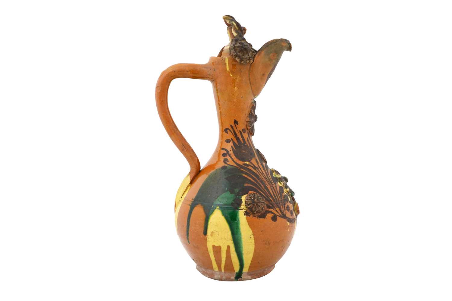 Lot 120 - AN ENAMELLED, YELLOW AND GREEN-SPLASHED AMBER-GLAZED CANAKKALE POTTERY EWER