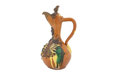 Lot 120 - AN ENAMELLED, YELLOW AND GREEN-SPLASHED AMBER-GLAZED CANAKKALE POTTERY EWER
