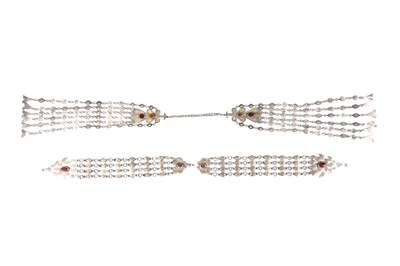 Lot 255 - TWO TURKMEN TEKKE TRIBE CARNELIAN-SET PARCEL-GILT SILVER LONG CEREMONIAL NECKLACES