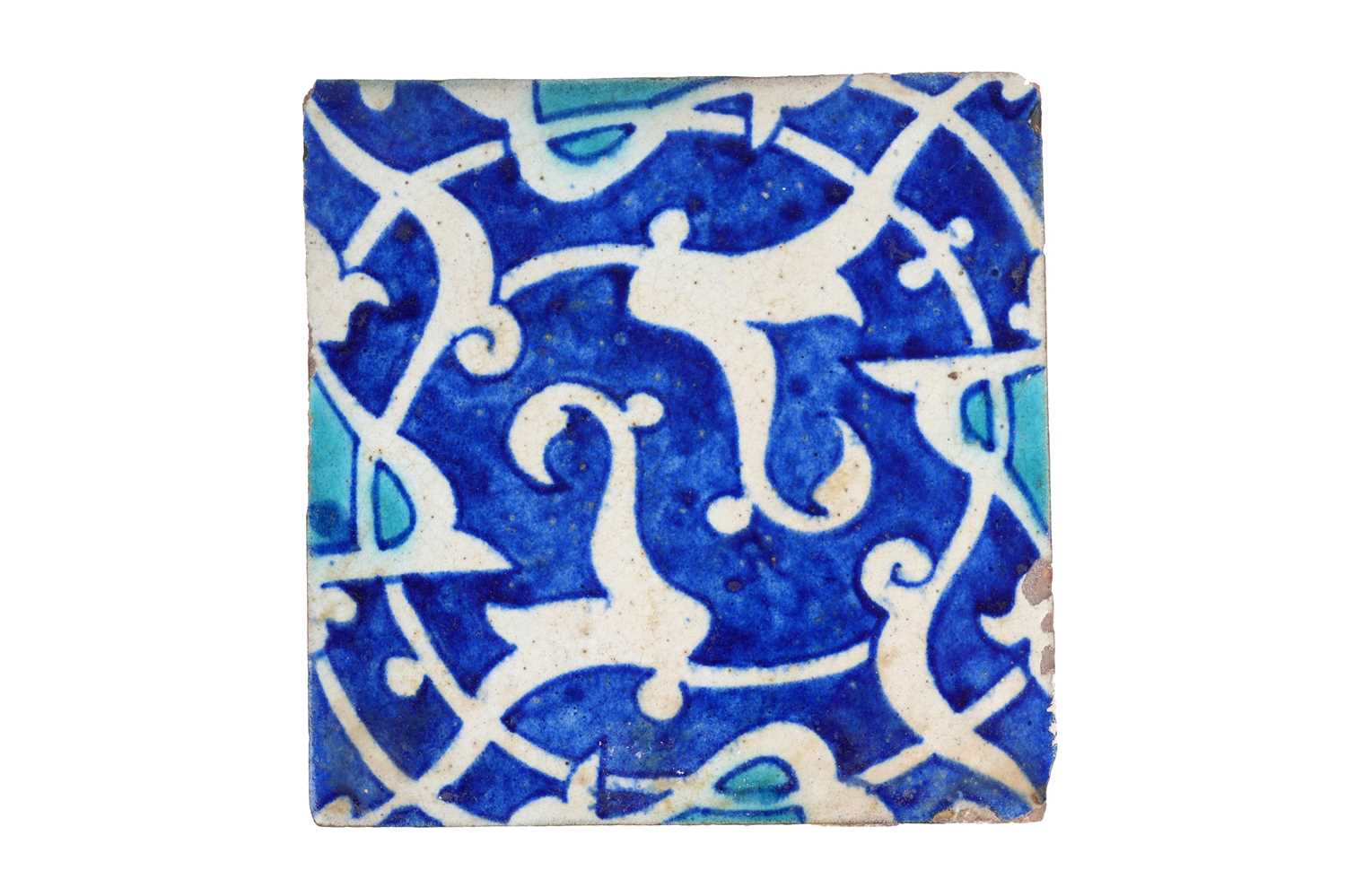 Lot 152 - AN INDIAN POTTERY TILE WITH SPLIT PALMETTE SPIRAL