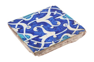 Lot 152 - AN INDIAN POTTERY TILE WITH SPLIT PALMETTE SPIRAL