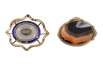 Lot 21 - A PAIR OF VICTORIAN AGATE AND ENAMEL BROOCHES.