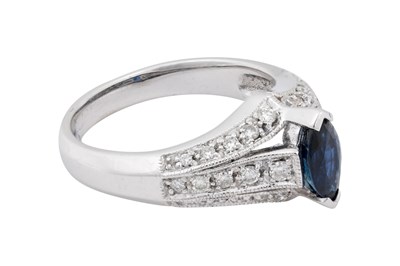Lot 20 - A 18K WHITE GOLD MARQUISE-CUT SAPPHIRE AND DIAMOND COCKTAIL RING.
