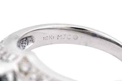 Lot 20 - A 18K WHITE GOLD MARQUISE-CUT SAPPHIRE AND DIAMOND COCKTAIL RING.