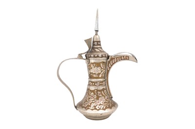 Lot 64 - A WHITE METAL PLATED BRASS DALLAH COFFEE POT