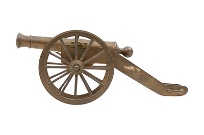 Lot 130 - A MINIATURE BRASS CANNON
