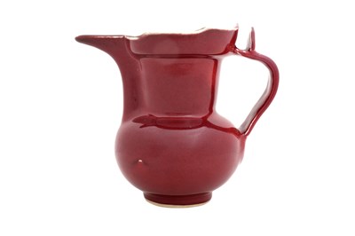 Lot 34 - A CHINESE COPPER RED-GLAZED MONK'S CAP EWER