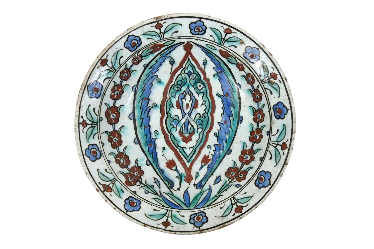 Lot 133 - AN IZNIK POTTERY DISH WITH ARABESQUE, SAZ LEAVES, AND FLORAL DECORATION