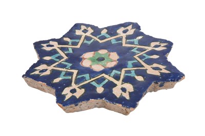 Lot 234 - A COBALT BLUE-PAINTED TIMURID-REVIVAL STAR-SHAPED POTTERY TILE