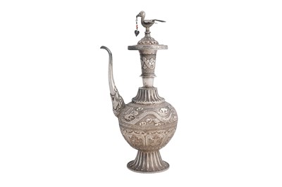 Lot 194 - A SINO-TIBETAN SILVER-EMBOSSED EWER
