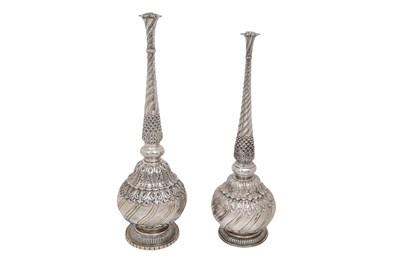 Lot 93 - A NEAR PAIR OF INDIAN PARCEL-GILT EMBOSSED SILVER ROSEWATER SPRINKLERS (GULABPASH)