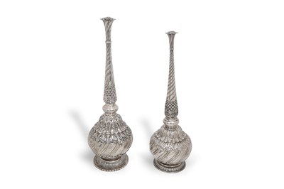 Lot 93 - A NEAR PAIR OF INDIAN PARCEL-GILT EMBOSSED SILVER ROSEWATER SPRINKLERS (GULABPASH)