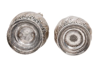 Lot 93 - A NEAR PAIR OF INDIAN PARCEL-GILT EMBOSSED SILVER ROSEWATER SPRINKLERS (GULABPASH)