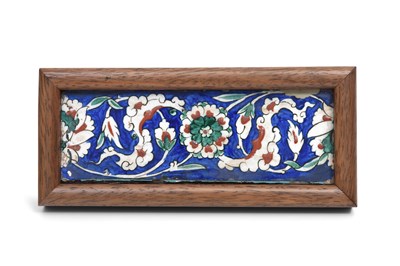 Lot 167 - AN IZNIK POTTERY BORDER TILE PANEL WITH ROSETTES AND CLOUD COLLAR