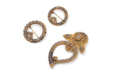 Lot 59 - THREE ENCRUSTED PARCEL-GILT BROOCHES