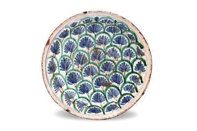 Lot 226 - A SPANISH BLUE AND GREEN-PAINTED POTTERY CHARGER WITH PALMETTES