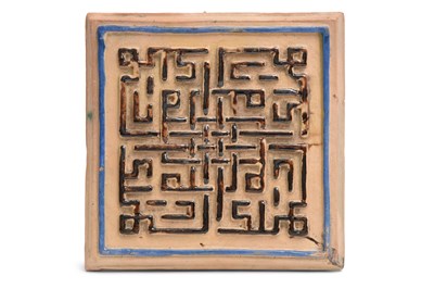 Lot 61 - A MOULDED POTTERY TILE WITH SQUARE KUFIC CALLIGRAPHY