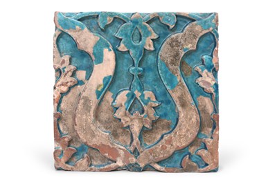 Lot 62 - AN INDIAN MONOCHROME TURQUOISE-GLAZED MOULDED POTTERY TILE