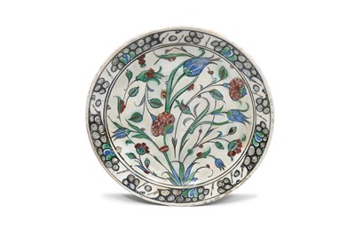 Lot 174 - AN IZNIK POTTERY DISH WITH RED CARNATIONS AND BLUE TULIPS