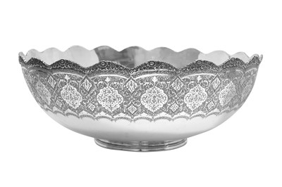 Lot 109 - A LARGE ENGRAVED IRANIAN SILVER BOWL AND TRAY BY MAHMUD RABI'I