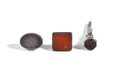 Lot 22 - THREE MOUNTED INTAGLIO SEALS WITH SHI'A IMAMS' NAMES