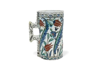 Lot 172 - AN IZNIK POTTERY TANKARD WITH TULIPS AND SAZ LEAVES